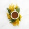 Cup of white coffee with yeallow mimosa flowers. Flat lay, top view.