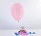 Cupcake with balloon on white background