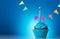 Cupcake birthday with candle beautiful on bright blue background