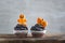 Cupcake for the celebration of Halloween on wooden table. Halloween cupcake with pumpkins and gingerbread man