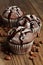 Cupcake with chocolate on wood background