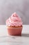 Cupcake decorated with pink strawberry frosting