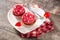 Cupcake decorated with sugar hearts and a cupid arrow for Valentine`s Day on wood