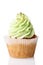 Cupcake with green cream isolated on white