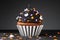 Cupcake on Halloween. Dessert on Halloween party. Muffin decorated with colored sprinkles, black frosting, icing