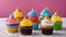 cupcake with icing A bright and cheerful photo of six birthday cupcakes with rainbow colors.