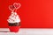 Cupcake love: Heart-themed treats on a vibrant red backdrop