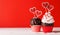 Cupcake love: Heart-themed treats on a vibrant red backdrop