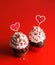 Cupcake love: Heart-themed treats on a vibrant red backdrop