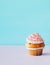 Cupcake muffin with cream and sugar sprinkles isolated