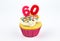 Cupcake with number sixty - 60 - pink candles with white vanilla