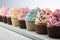 Cupcake parade row of vibrant birthday treats shines against a white background