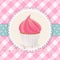 Cupcake with pink icing on pink gingham background