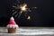 Cupcake with red swirl frosting and sparkler, christmas cupcake