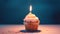 A cupcake with a single candle, typically used as a symbol for a birthday celebration