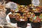 Cupcake varieties with decorative plate with the phrase `Carrot cake with brigadier` on the wooden table.