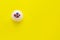 Cupcake with whipped cream and berries, confectionery products on a yellow background.