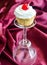 Cupcake with whipped cream and maraschino cherry