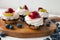 cupcakes with cottage cheese on vintage tray-tasty muffin with strawberry and kiwi on wooden plate