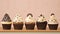 Cupcakes with cream and chocolate on wooden table