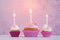 Cupcakes with cream and sugar hearts and birthday candle