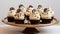Cupcakes decorated with chocolate and cream on a tray and white background