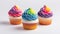 cupcakes decorated with pride rainbow on white background
