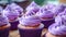 Cupcakes decorated with purple buttercream frosting, selective focus.