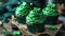 Cupcakes with green cream and filling and shamrock on top