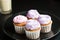 Cupcakes with a lilac cream on the plate