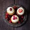 Cupcakes on metal tray decorated with berries