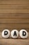 Cupcakes with text dad on arranged wooden plank