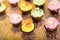 Cupcakes. yellow, green and pink cakes.