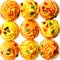 Cupcakes with yellow and orange frosting and colored sprinkles. Background. Sweet food for Halloween