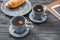 Cups of delicious camomile tea on wooden table