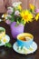 Cups of herbal tea with camomile and mint leaves on the wooden background