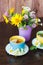 Cups of herbal tea with camomile and mint leaves on the wooden background