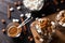 Cups with hot chocolate and marshmallows on cutting board between cinnamon, top view