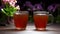 Cups with hot tea on a cozy evening table. Kalanchoe and pelargonium