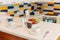 Cups, saucers and teaspoons on a white countertop in the kitchen.