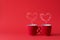 Cups of tea or coffee with steam in two heart shape on red background. Valentine`s day celebration or love concept. Copy space
