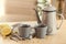 Cups and teapot with delicious camomile drink on table