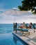 Curacao, couple man and woman mid age relaxing by the swimming pool during vacation