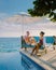 Curacao, couple man and woman mid age relaxing by the swimming pool during vacation