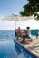 Curacao, couple man and woman mid age relaxing by the swimming pool during vacation in the Caribbean