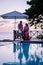 Curacao, couple man and woman mid age relaxing by the swimming pool during vacation, men and girl by pool in Curacao