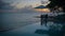 Curacao, couple on vacation in Curacao watching sunset by the pool