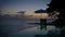 Curacao, couple on vacation in Curacao watching sunset by the pool