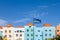 Curacao Flag by Blue Buildings under Blue Skies