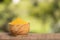 Curcuma longa - Turmeric powder. Wooden table in the park among the trees on a summer day. Text space